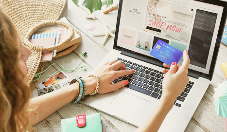 Entrepreneur managing an online store and business finances on a laptop.